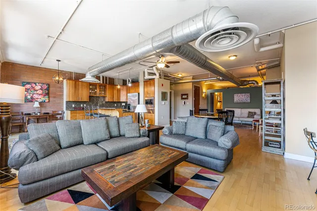 a living room with furniture a ceiling fan and a rug
