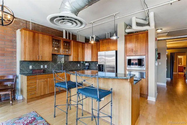 a kitchen with stainless steel appliances granite countertop a sink and cabinets