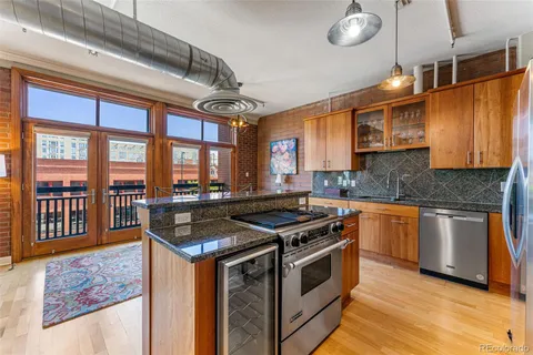 a kitchen with stainless steel appliances granite countertop a stove and a sink