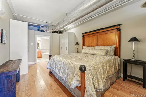 a bedroom with a bed and a mirror