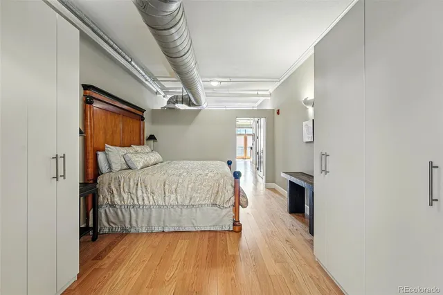 a bedroom with a bed and a mirror