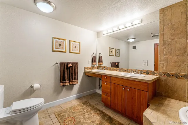 a spacious bathroom with a sink toilet and a mirror