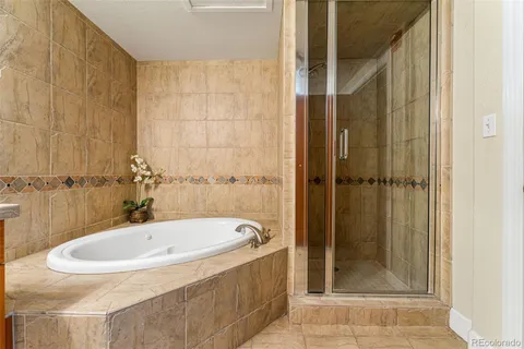 a bathroom with a tub and shower