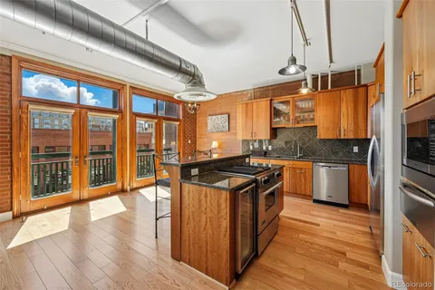 a kitchen with stainless steel appliances granite countertop a stove and a sink