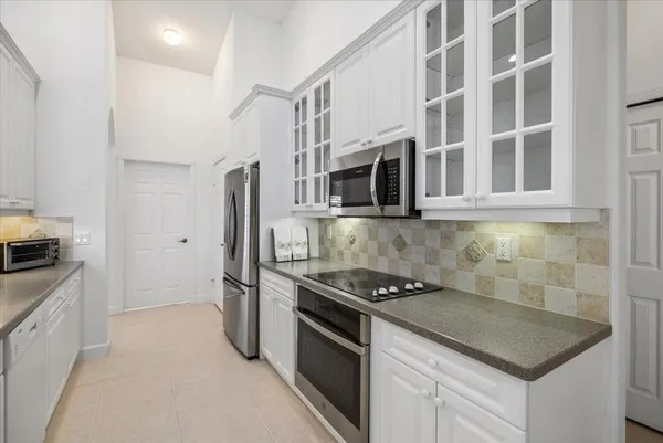 a kitchen with stainless steel appliances granite countertop a stove and a refrigerator