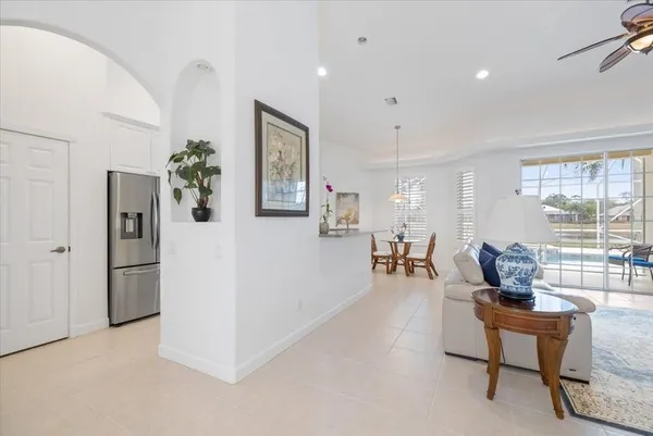 a living room with furniture and a dining table with wooden floor