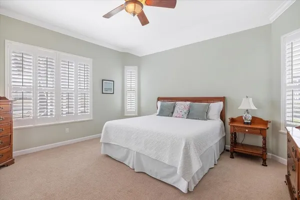 a spacious bedroom with a bed and a window