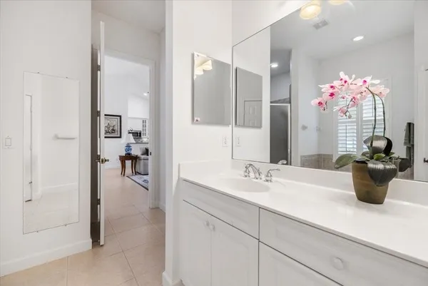 a bathroom with a sink a vanity and a mirror