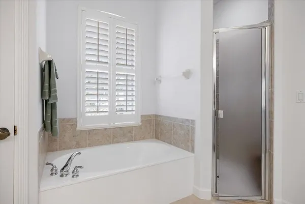 a bathroom with a bathtub and a shower