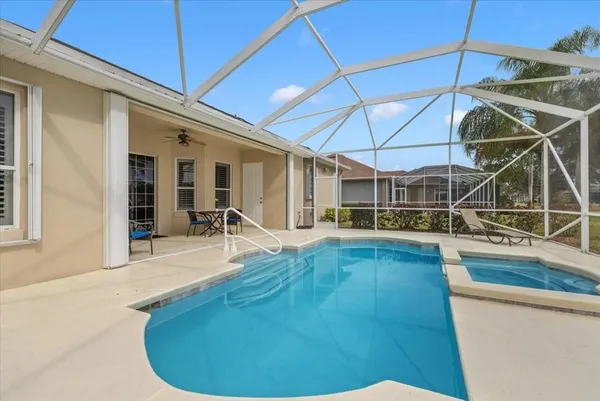 a view of a house with pool table and chairs