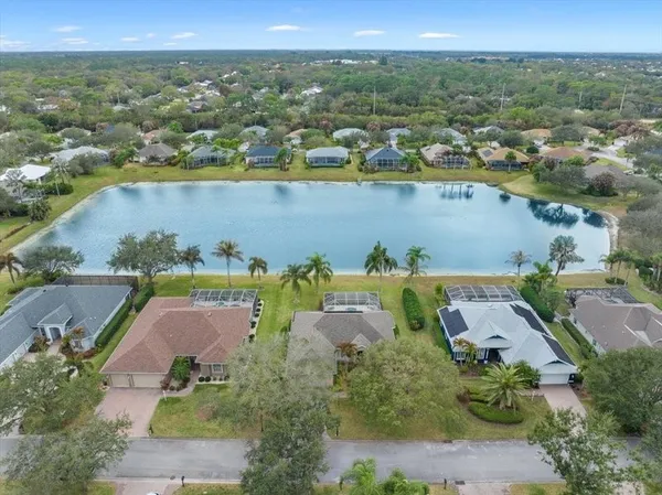 an aerial view of a house with a lake view