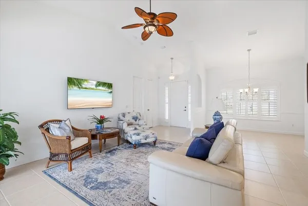 a living room with furniture and a chandelier