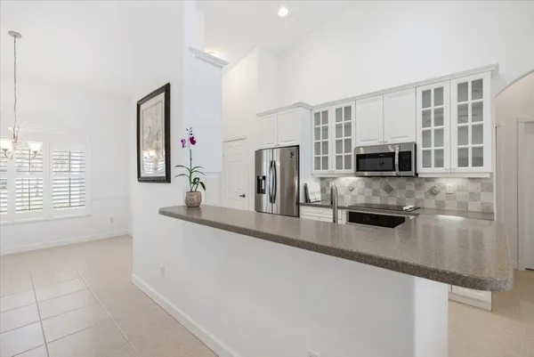 a kitchen with stainless steel appliances granite countertop a sink and a refrigerator