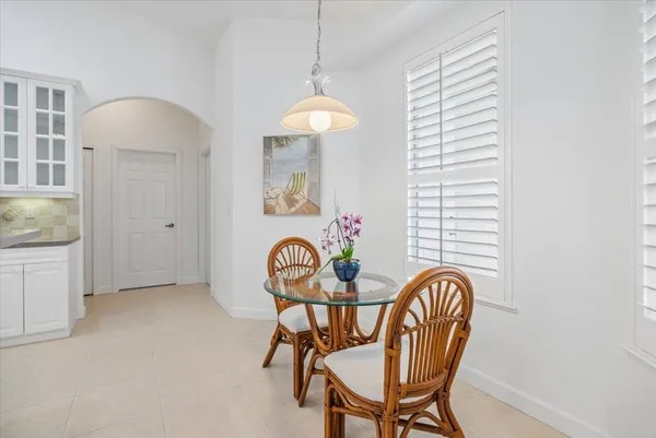 a view of a dining room with furniture and chandelier