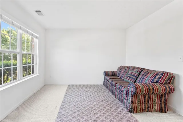 an aerial view of a tennis ground and a large tree