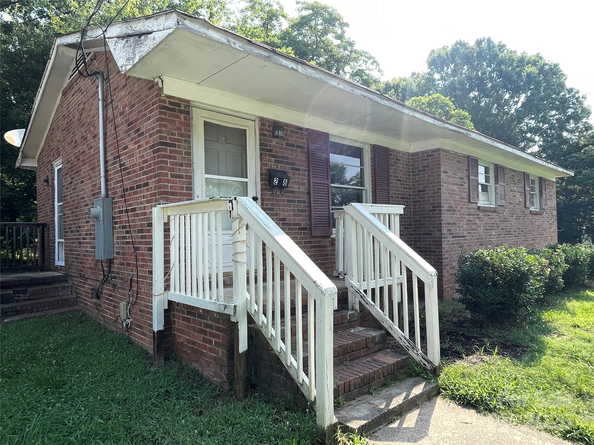 a view of house with a yard and deck