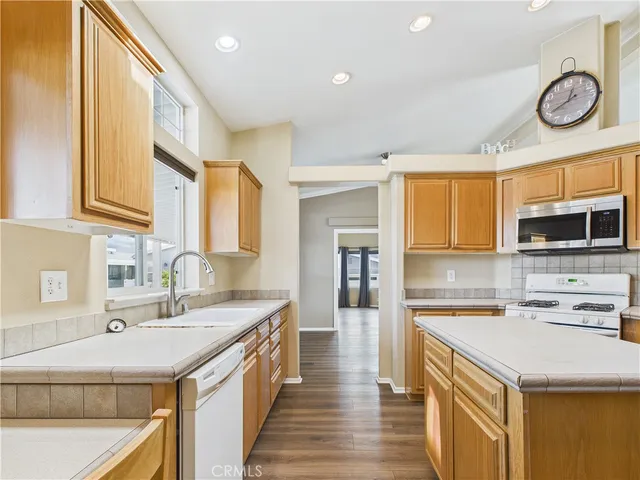 a kitchen with a sink a stove and cabinets