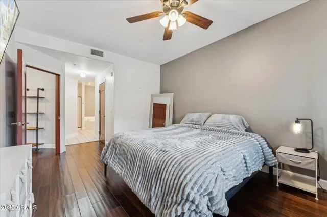 a bedroom with bed and wooden floor