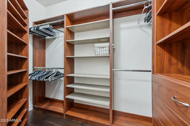 a view of walk in closet with empty racks