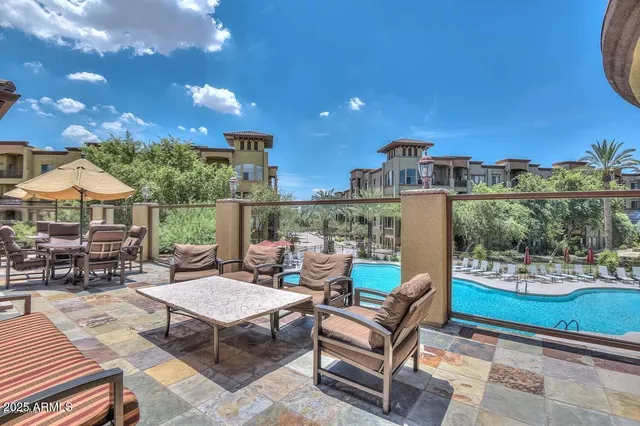 a building outdoor space with patio furniture and potted plants