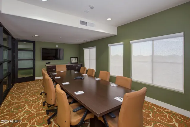 a living room with furniture a flat screen tv and kitchen view