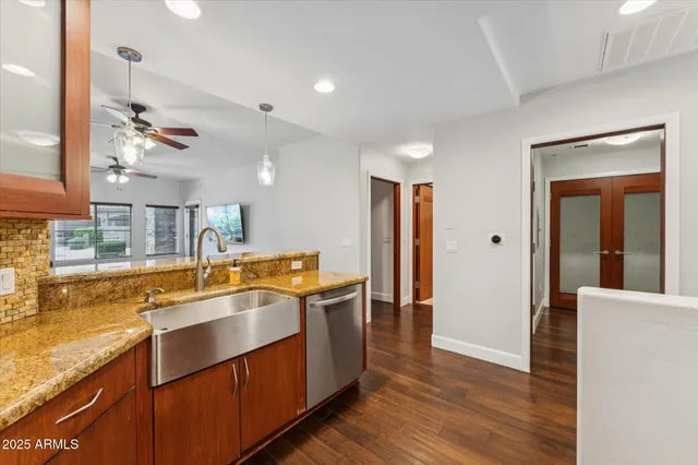 a view of a kitchen with a sink and wooden floor