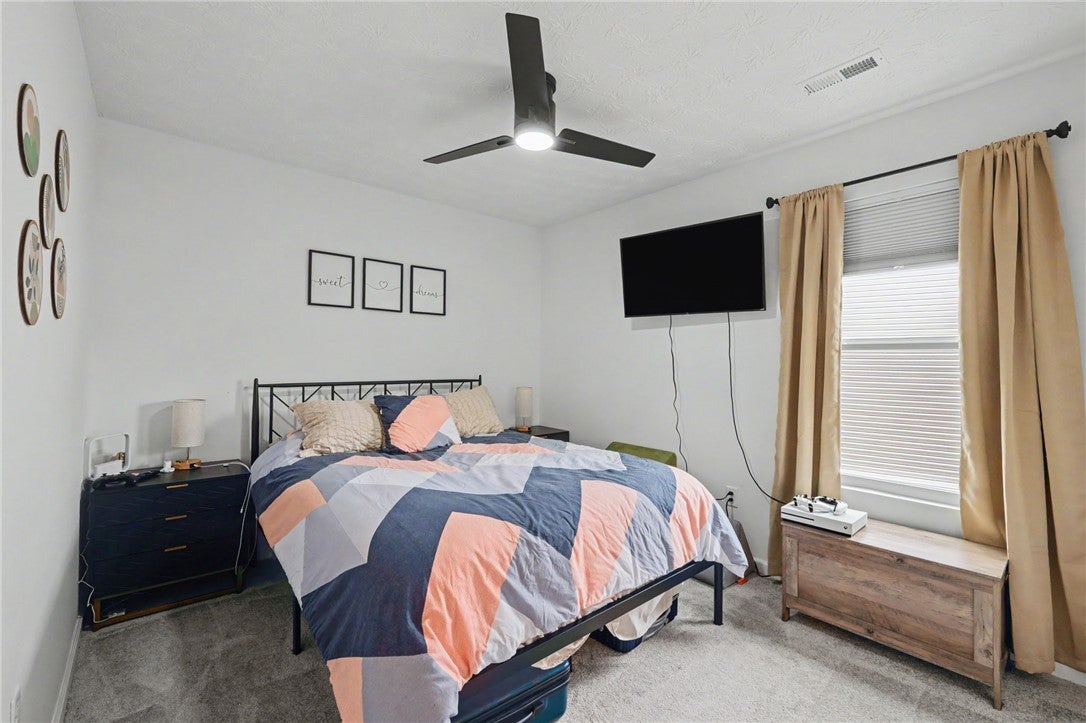 3011 Falls Road Clayton, OH 45315 - Photo 35 of 66 A well-lit bedroom featuring a sleek ceiling fan and ample natural illumination from a large window.