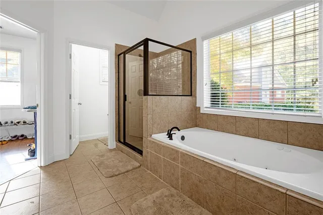 a bathroom with a bathtub and a shower