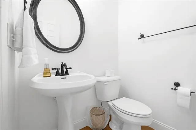 a white toilet sitting next to a bathroom sink