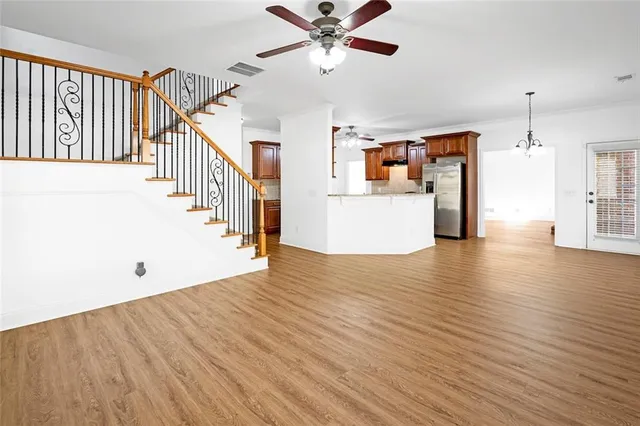 a kitchen with stainless steel appliances granite countertop wooden cabinets a stove a sink and dishwasher