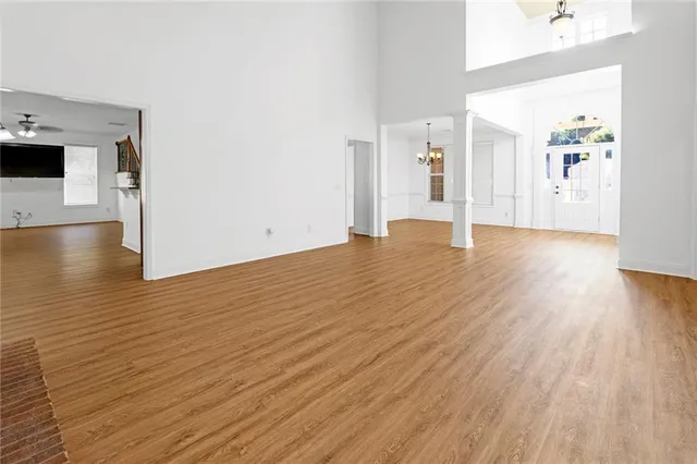 a view of empty room with wooden floor