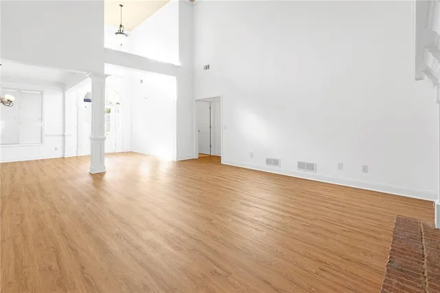a view of an empty room with wooden floor