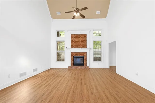a view of an empty room with a fireplace and a window