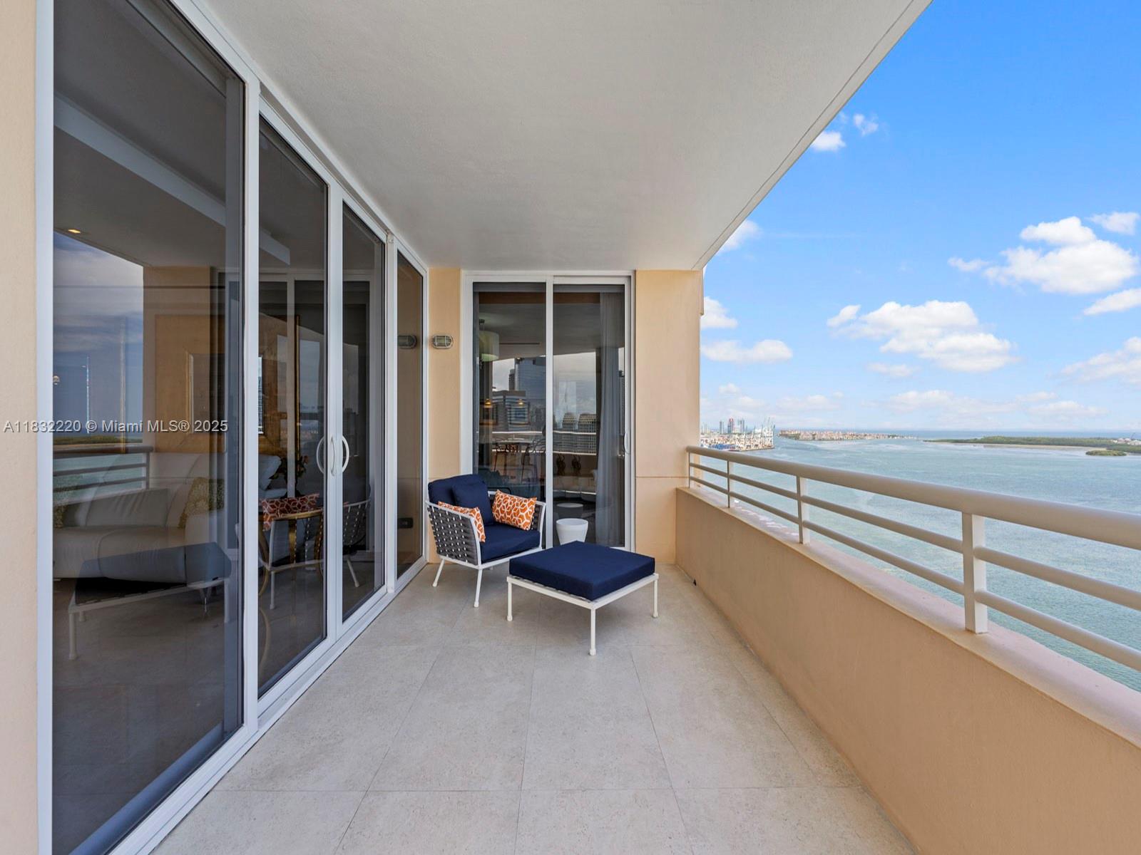 808 Brickell Key Drive, Unit 3208 Miami, FL 33131 - Photo 11 of 45 a living room with furniture and floor to ceiling window