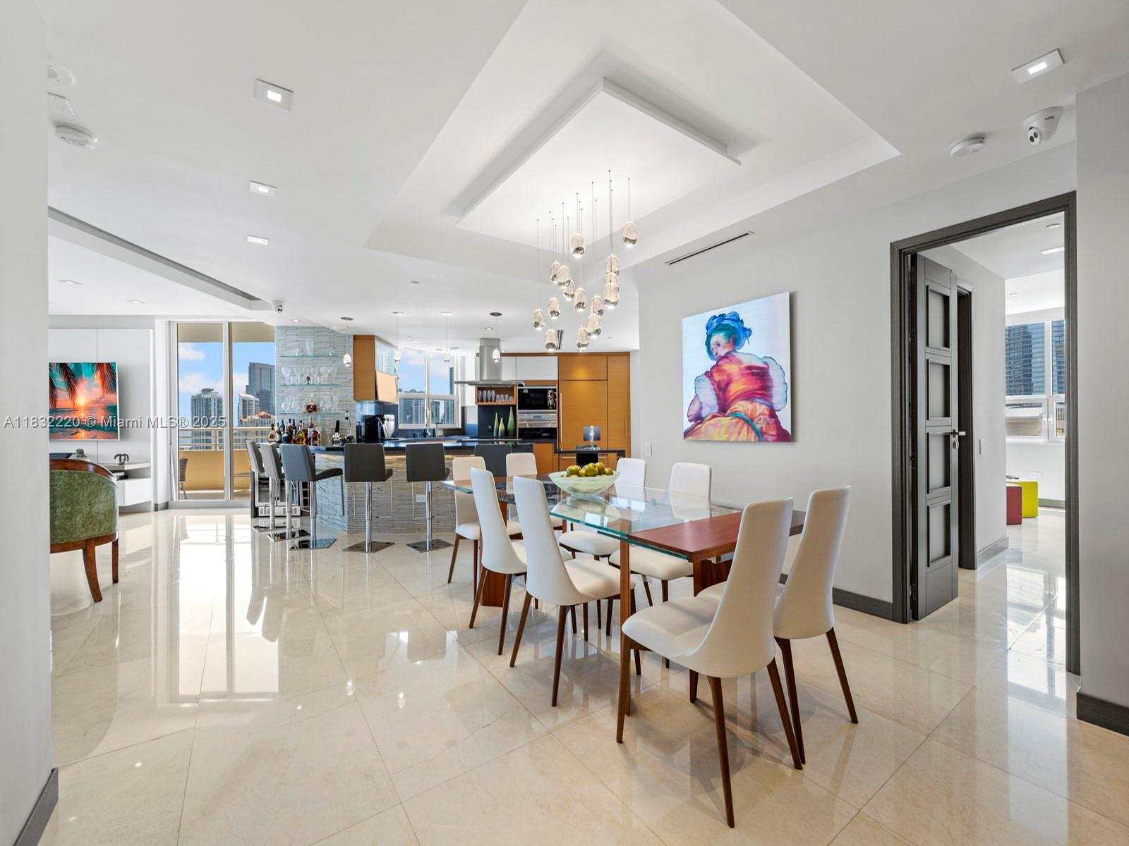 808 Brickell Key Drive, Unit 3208 Miami, FL 33131 - Photo 12 of 45 a dining room with furniture and wooden floor