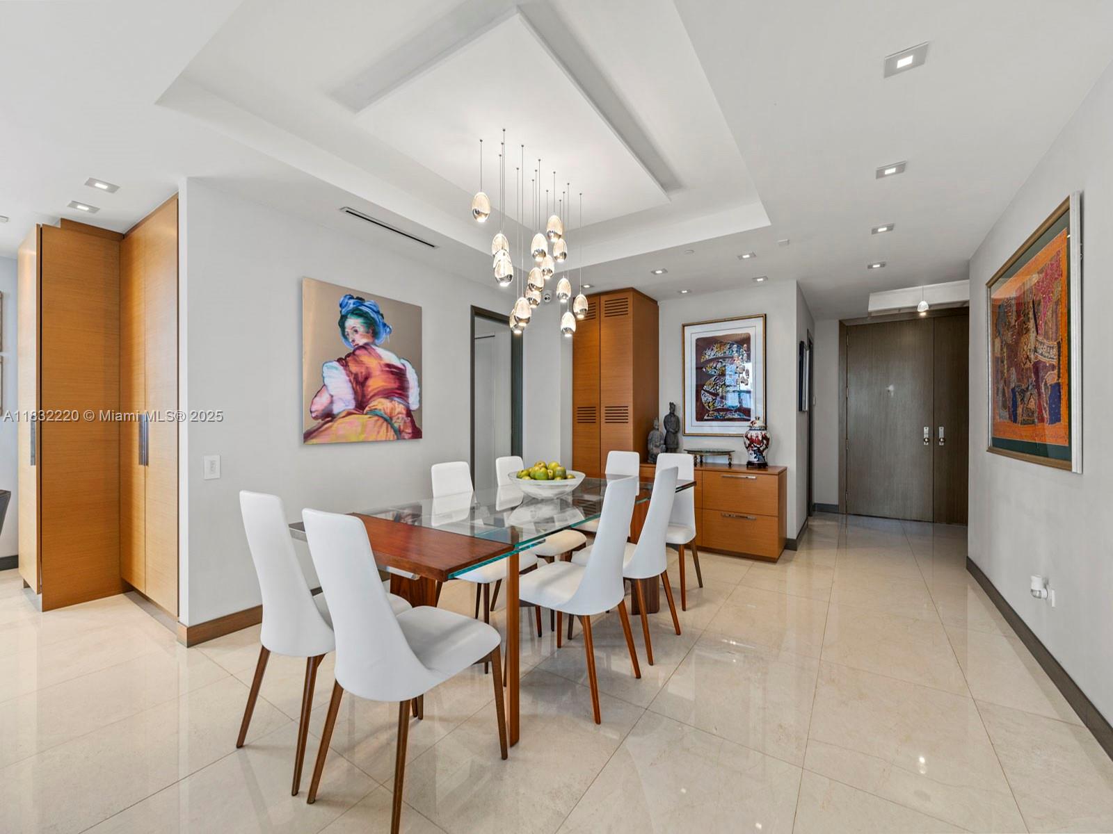 808 Brickell Key Drive, Unit 3208 Miami, FL 33131 - Photo 13 of 45 a view of a dining room with furniture and a chandelier