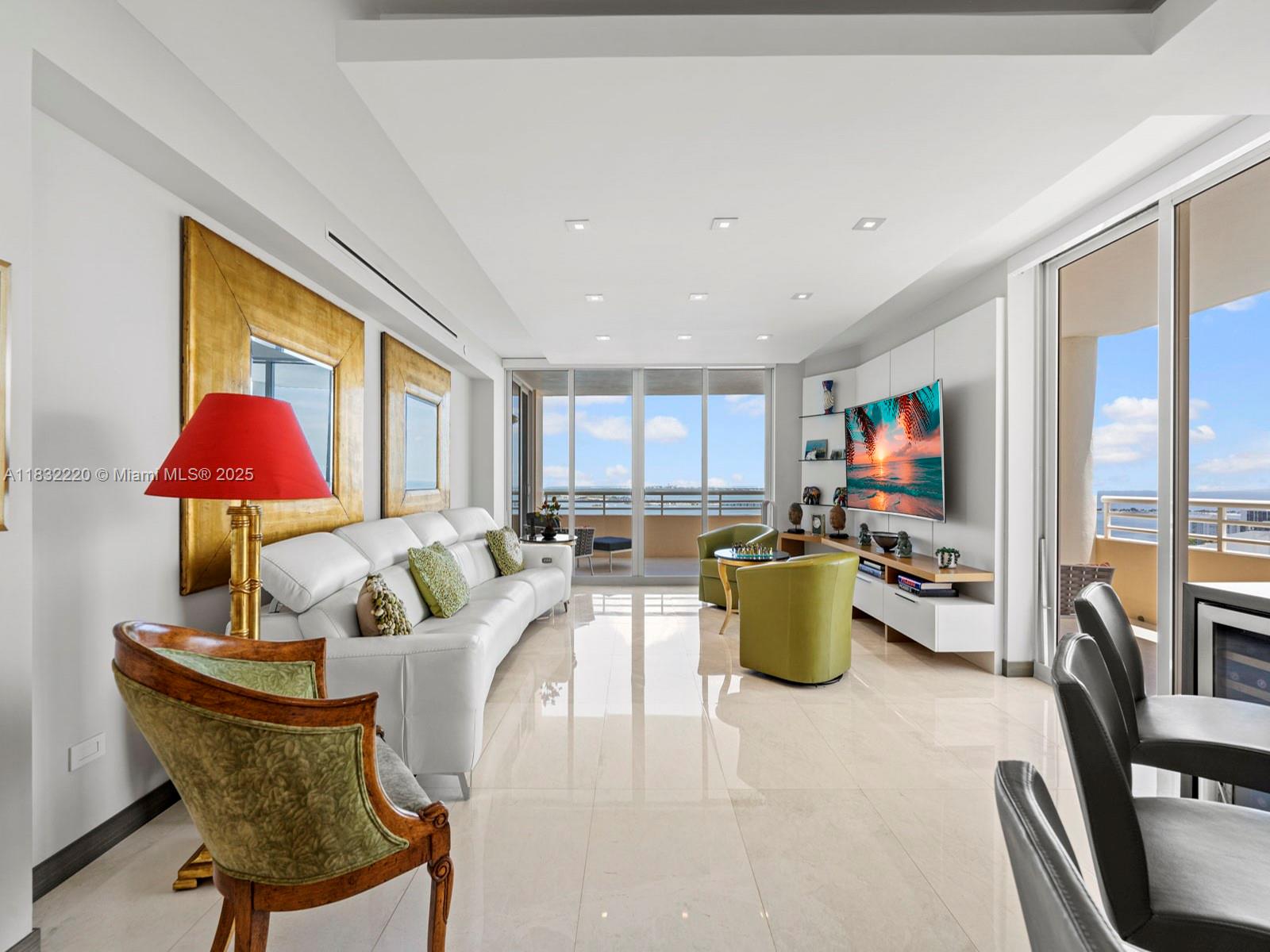 808 Brickell Key Drive, Unit 3208 Miami, FL 33131 - Photo 21 of 45 a living room with furniture and a chandelier