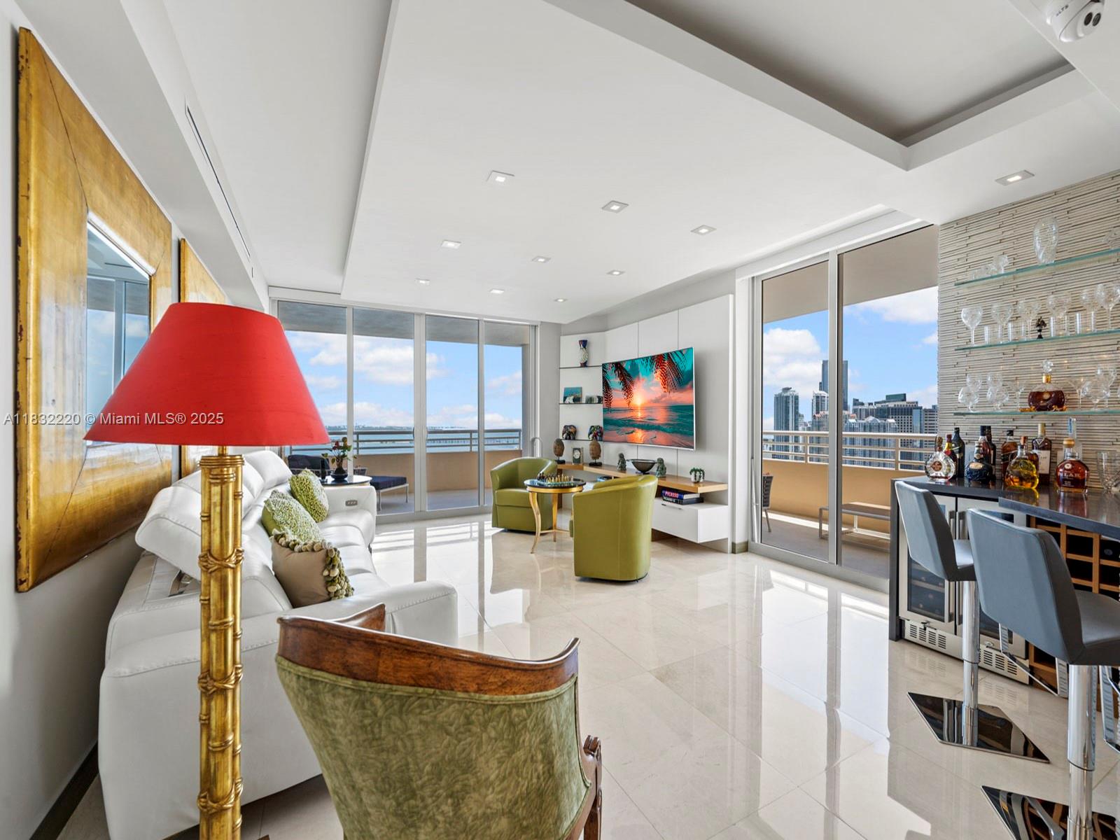 808 Brickell Key Drive, Unit 3208 Miami, FL 33131 - Photo 22 of 45 a living room with furniture and a flat screen tv