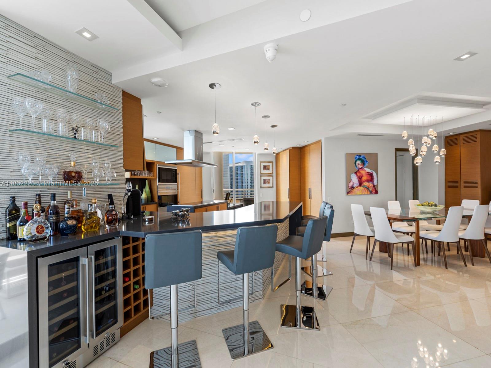 808 Brickell Key Drive, Unit 3208 Miami, FL 33131 - Photo 23 of 45 a large kitchen with lots of furniture and appliances