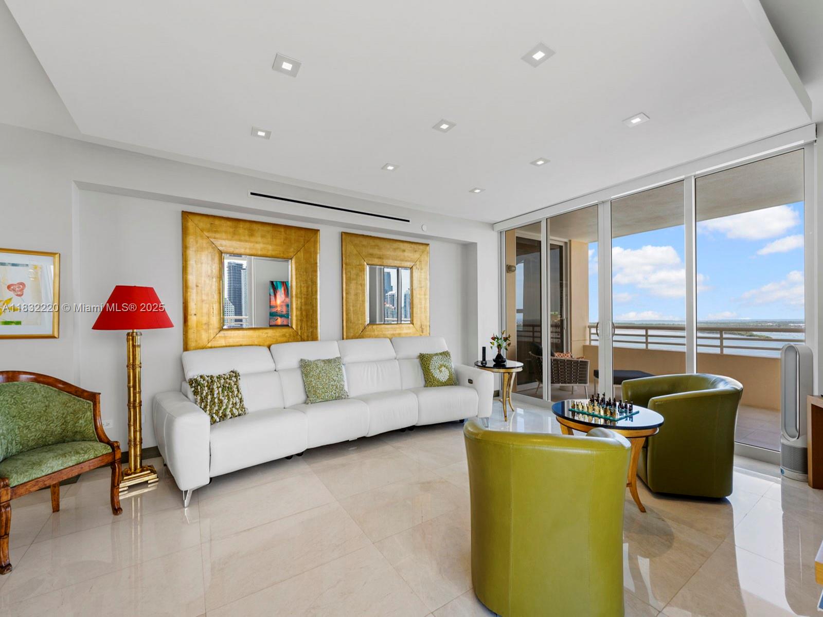 808 Brickell Key Drive, Unit 3208 Miami, FL 33131 - Photo 24 of 45 a living room with furniture and a large window