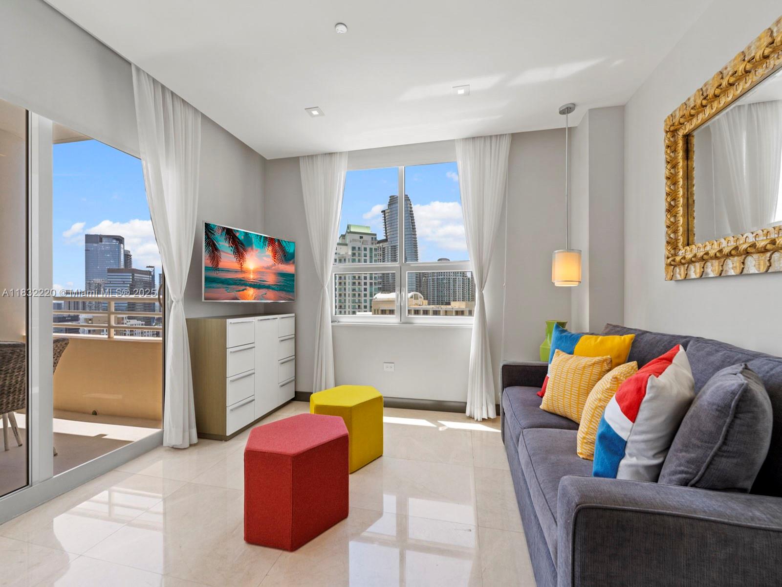 808 Brickell Key Drive, Unit 3208 Miami, FL 33131 - Photo 32 of 45 a living room with furniture and a flat screen tv