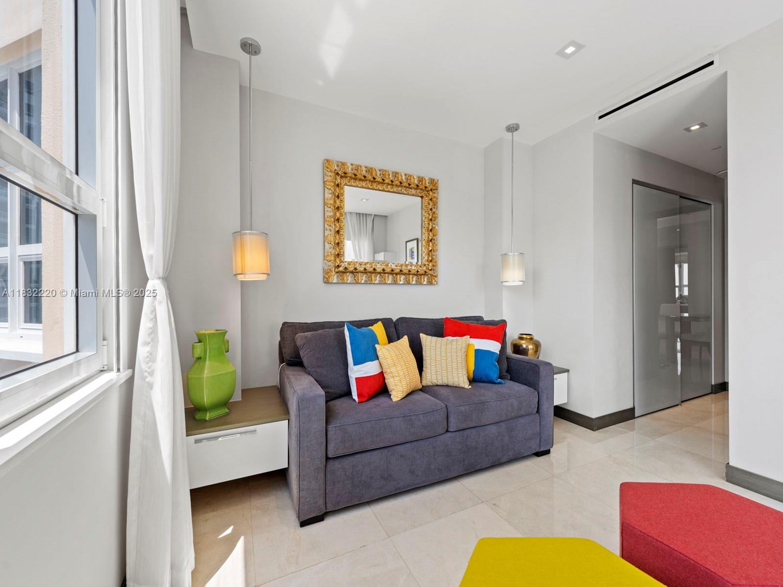 808 Brickell Key Drive, Unit 3208 Miami, FL 33131 - Photo 33 of 45 a living room with furniture and a rug