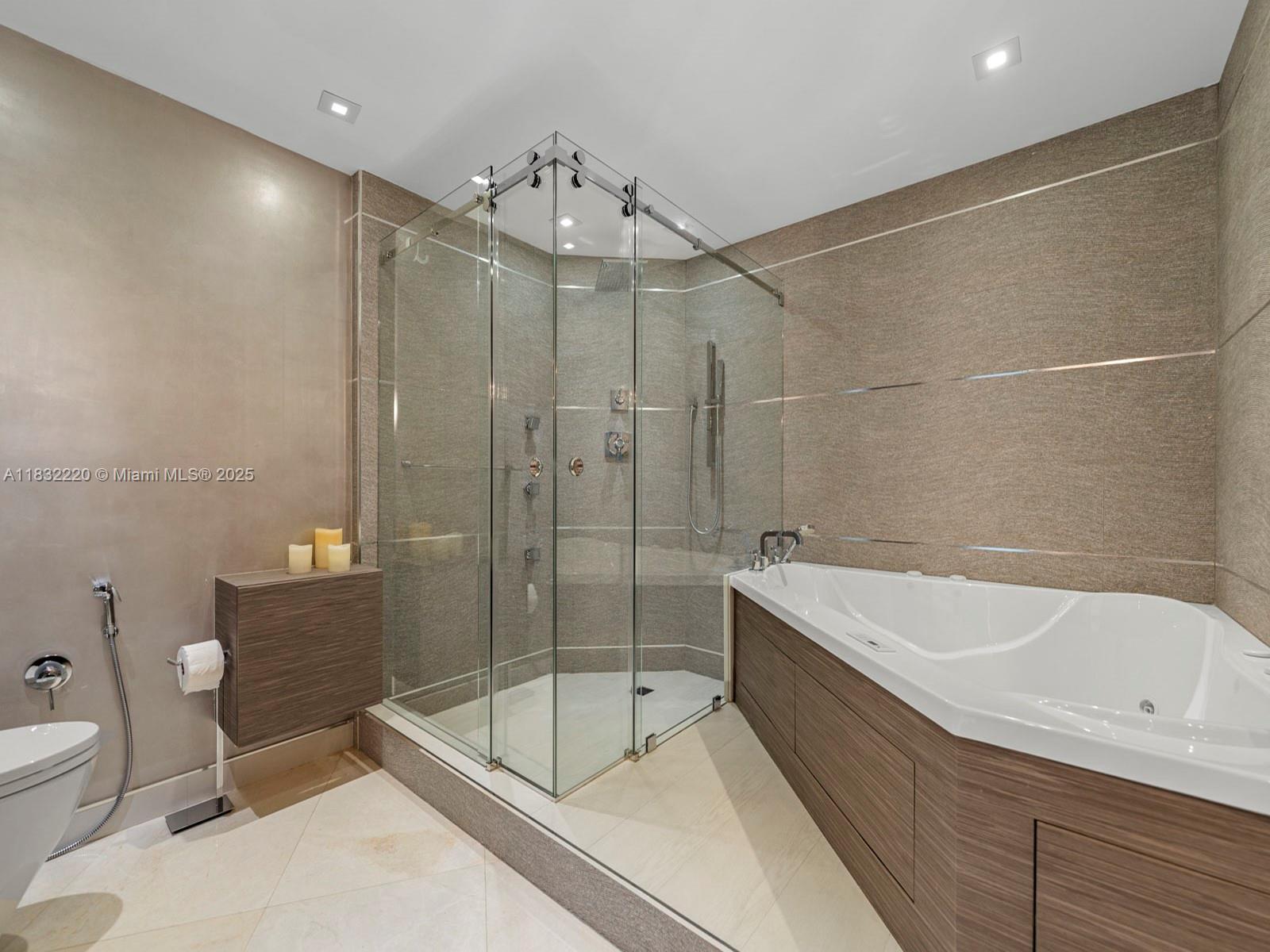 808 Brickell Key Drive, Unit 3208 Miami, FL 33131 - Photo 38 of 45 a bathroom with a bathtub and a shower