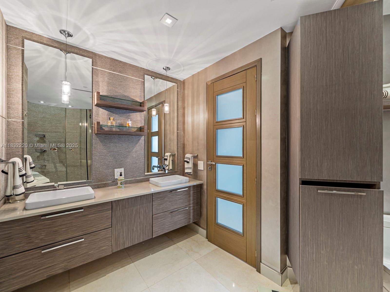 808 Brickell Key Drive, Unit 3208 Miami, FL 33131 - Photo 39 of 45 a bathroom with a double vanity sink mirror and shower