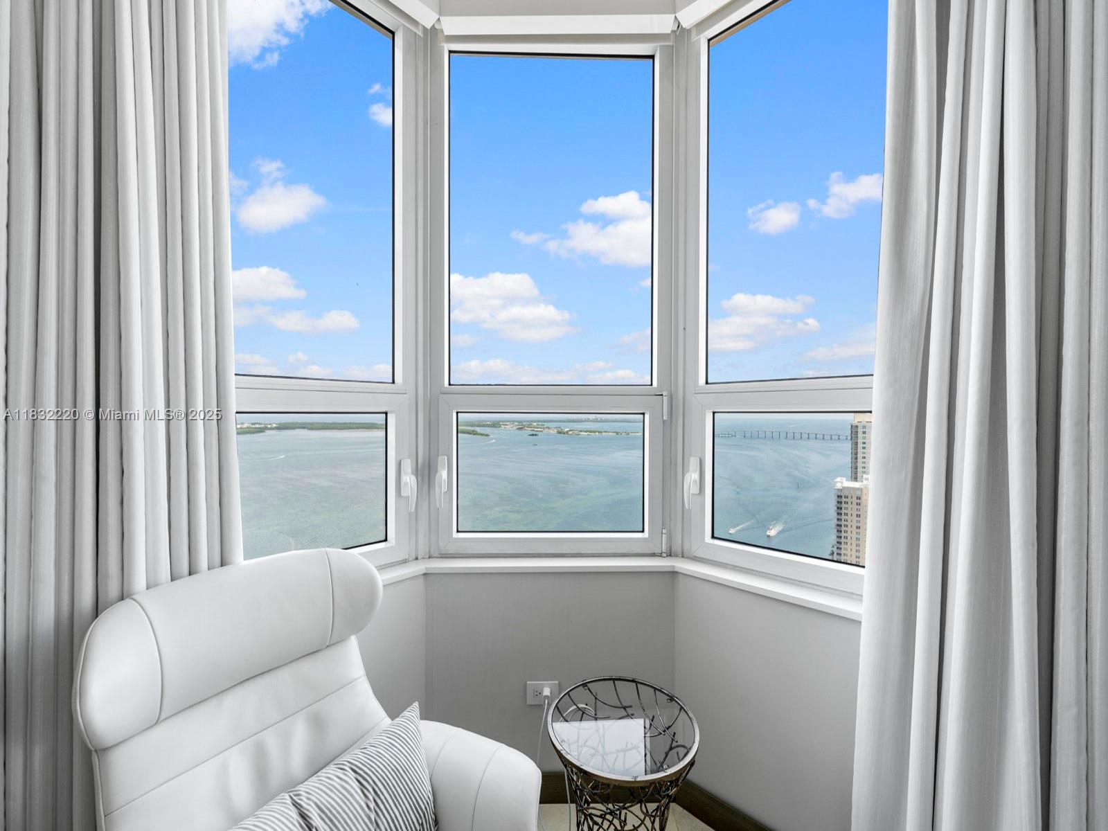 808 Brickell Key Drive, Unit 3208 Miami, FL 33131 - Photo 43 of 45 a living room with furniture and a window