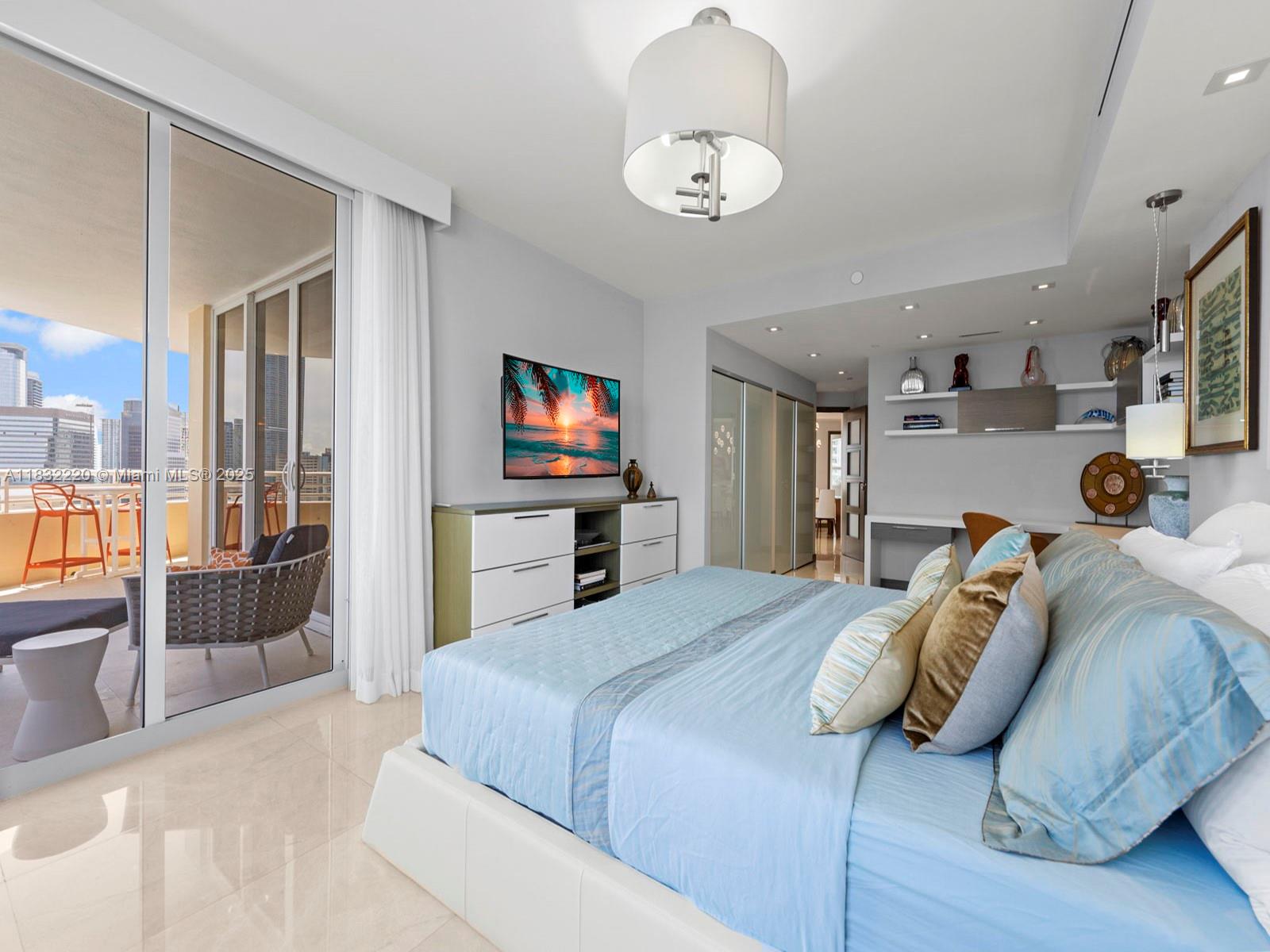 808 Brickell Key Drive, Unit 3208 Miami, FL 33131 - Photo 44 of 45 a bedroom with bed and a chandelier