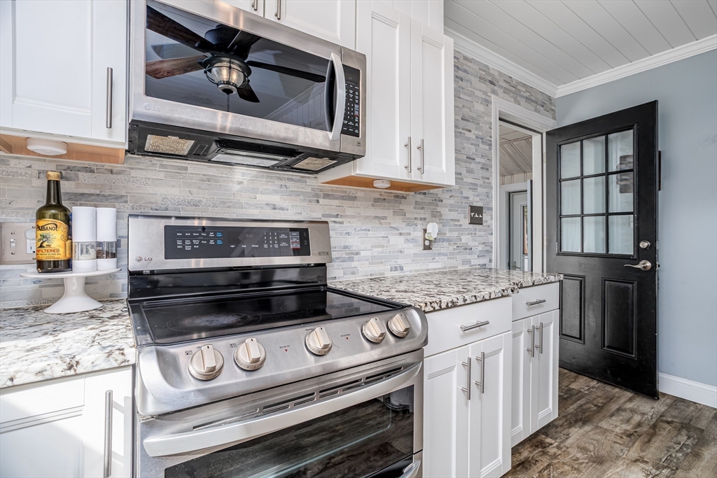 37 Rouville Avenue Gardner, MA 01440 - Photo 11 of 42 a kitchen with stainless steel appliances granite countertop a stove and a microwave