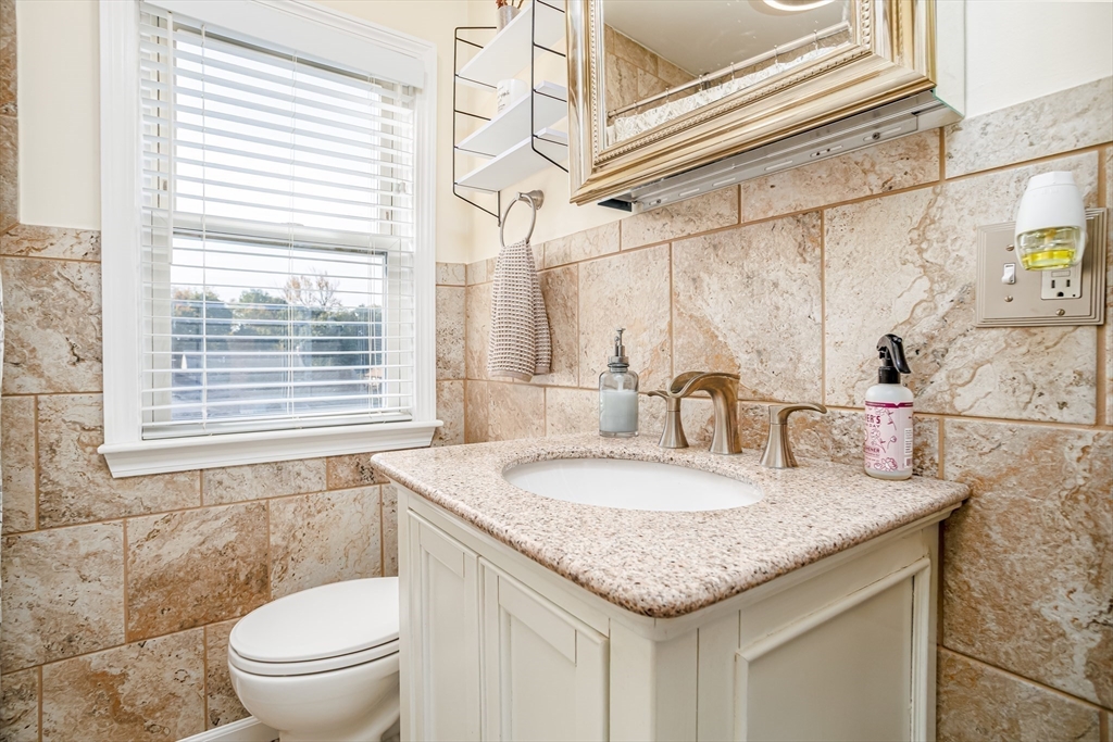 37 Rouville Avenue Gardner, MA 01440 - Photo 23 of 42 a bathroom with a granite countertop sink and a mirror