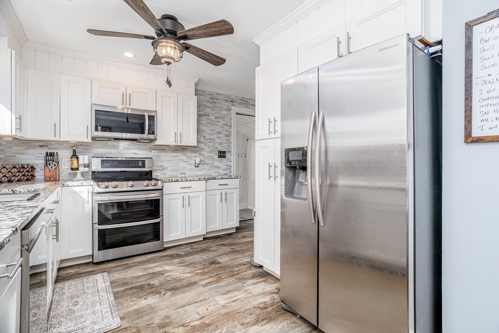 37 Rouville Avenue Gardner, MA 01440 - Photo 8 of 42 a kitchen with stainless steel appliances and a refrigerator