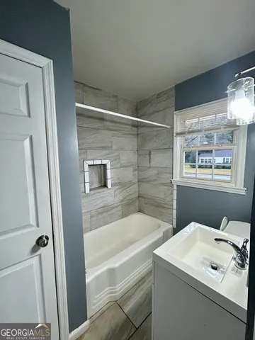 a bathroom with a bathtub and a shower